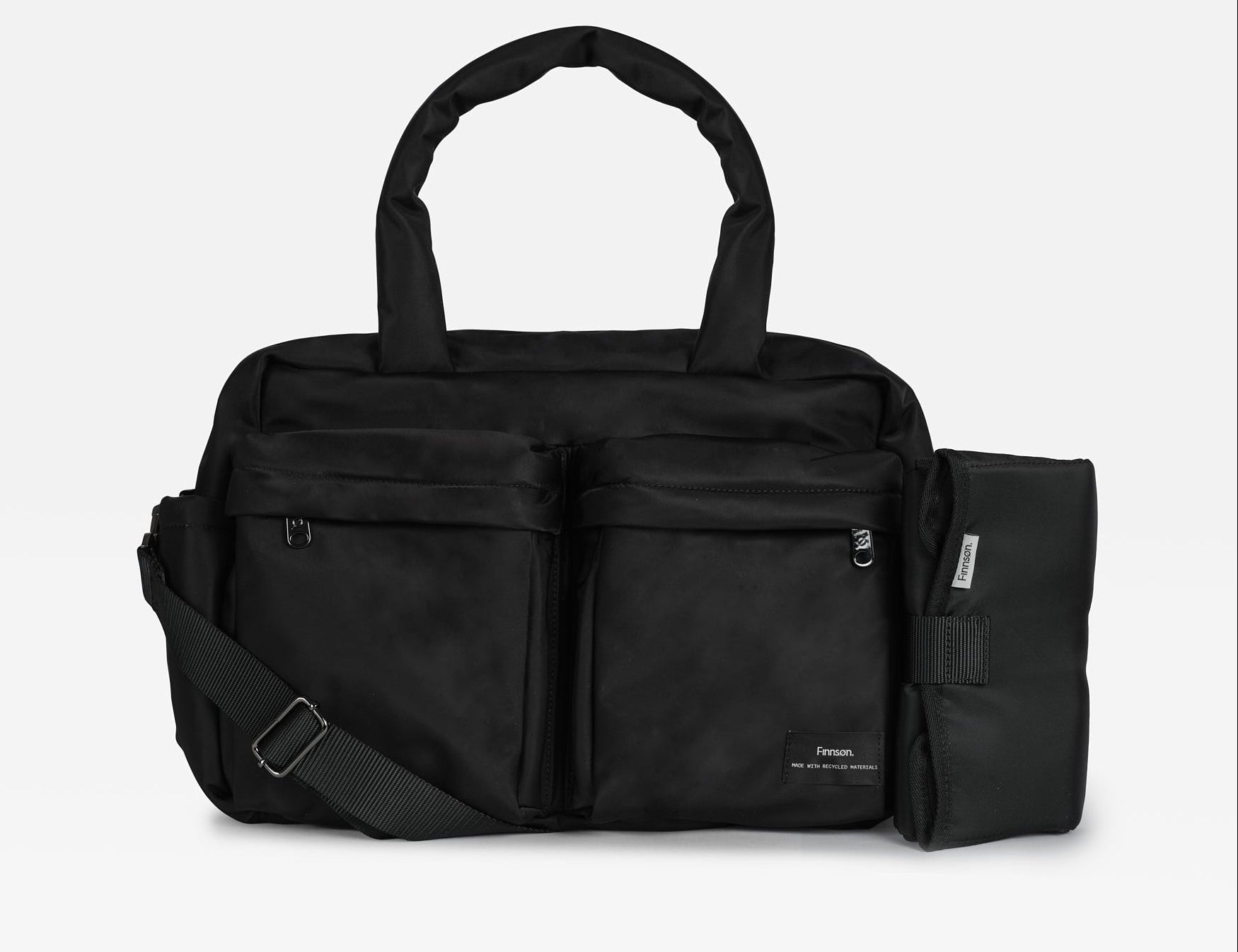 A black multi-compartment duffel bag with a detachable shoulder strap and an attached black pouch on the side, shown against a light gray background.
