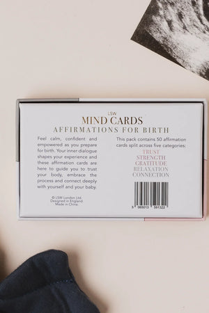 Box of 'MIND CARDS Affirmations for Birth' on a neutral background with a baby item and ultrasound photo.