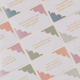 Set of cards with motivational phrases and cloud designs on a light background