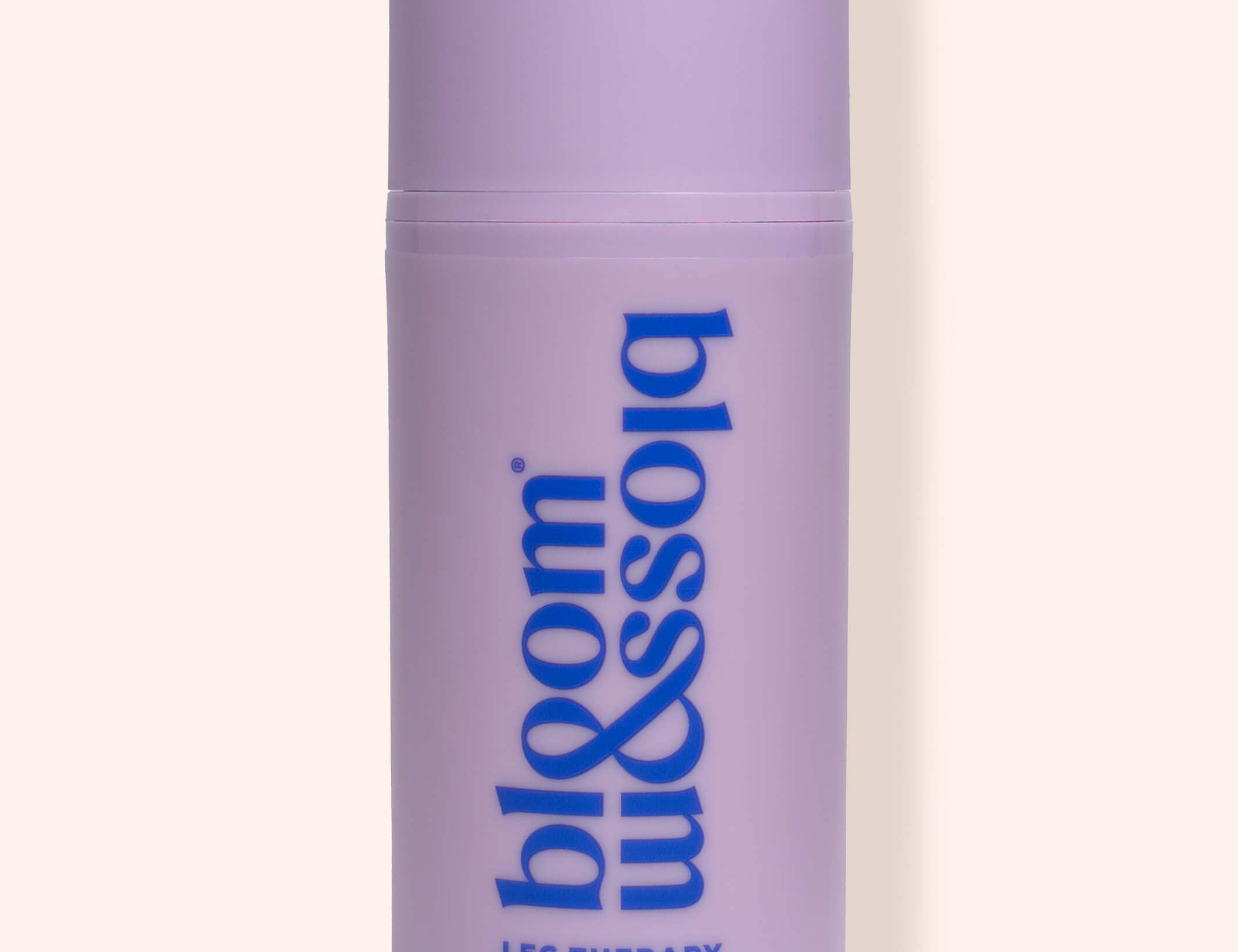A lavender purple cylindrical bottle of bloom & sojo Leg Therapy Cooling Leg Serum, featuring blue text on a light beige background.
