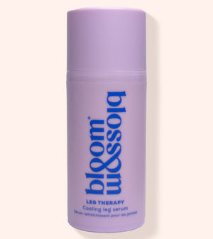 A lavender purple cylindrical bottle of bloom & sojo Leg Therapy Cooling Leg Serum, featuring blue text on a light beige background.