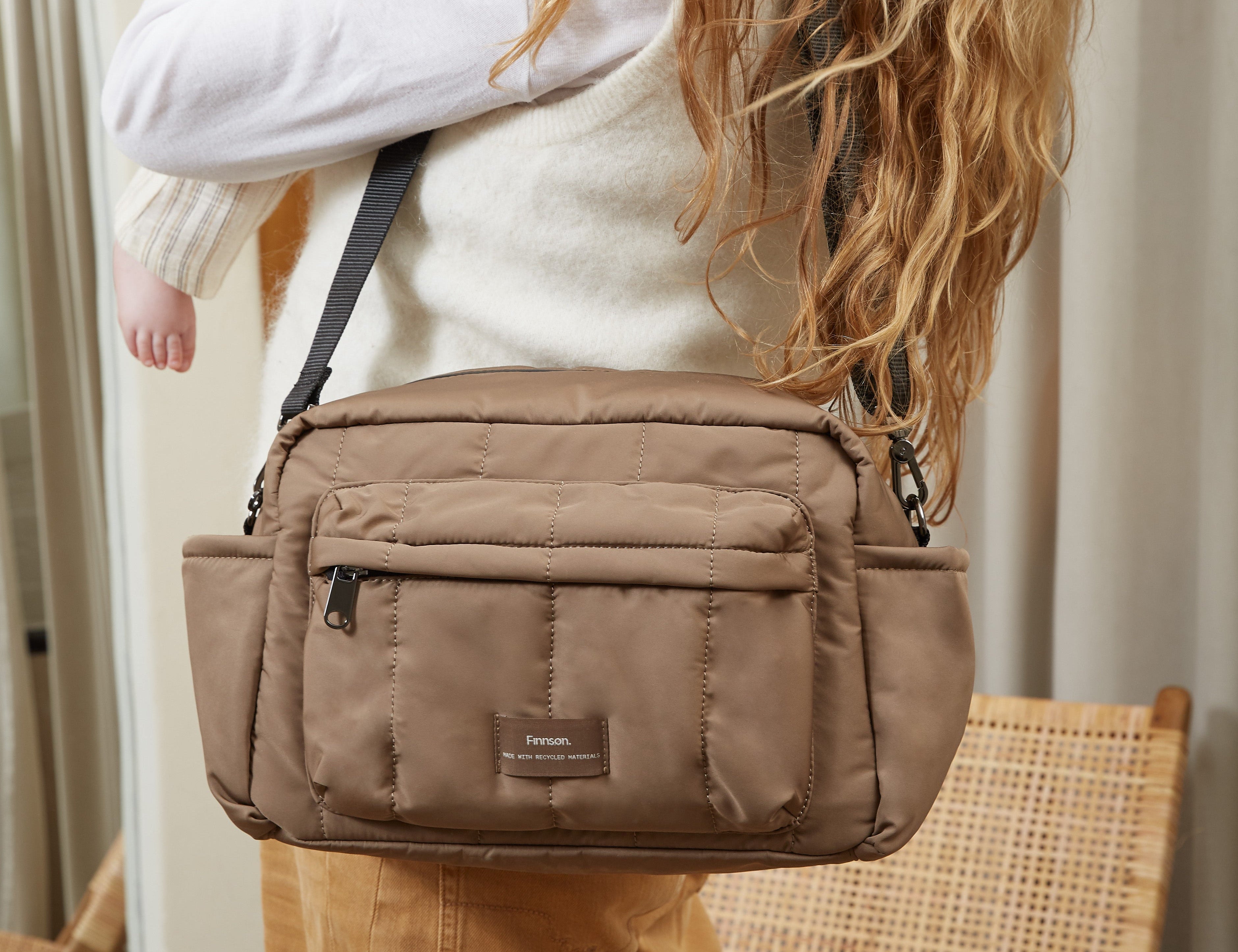 Freya stroller organiser in Mocha worn crossbody, seen from behind