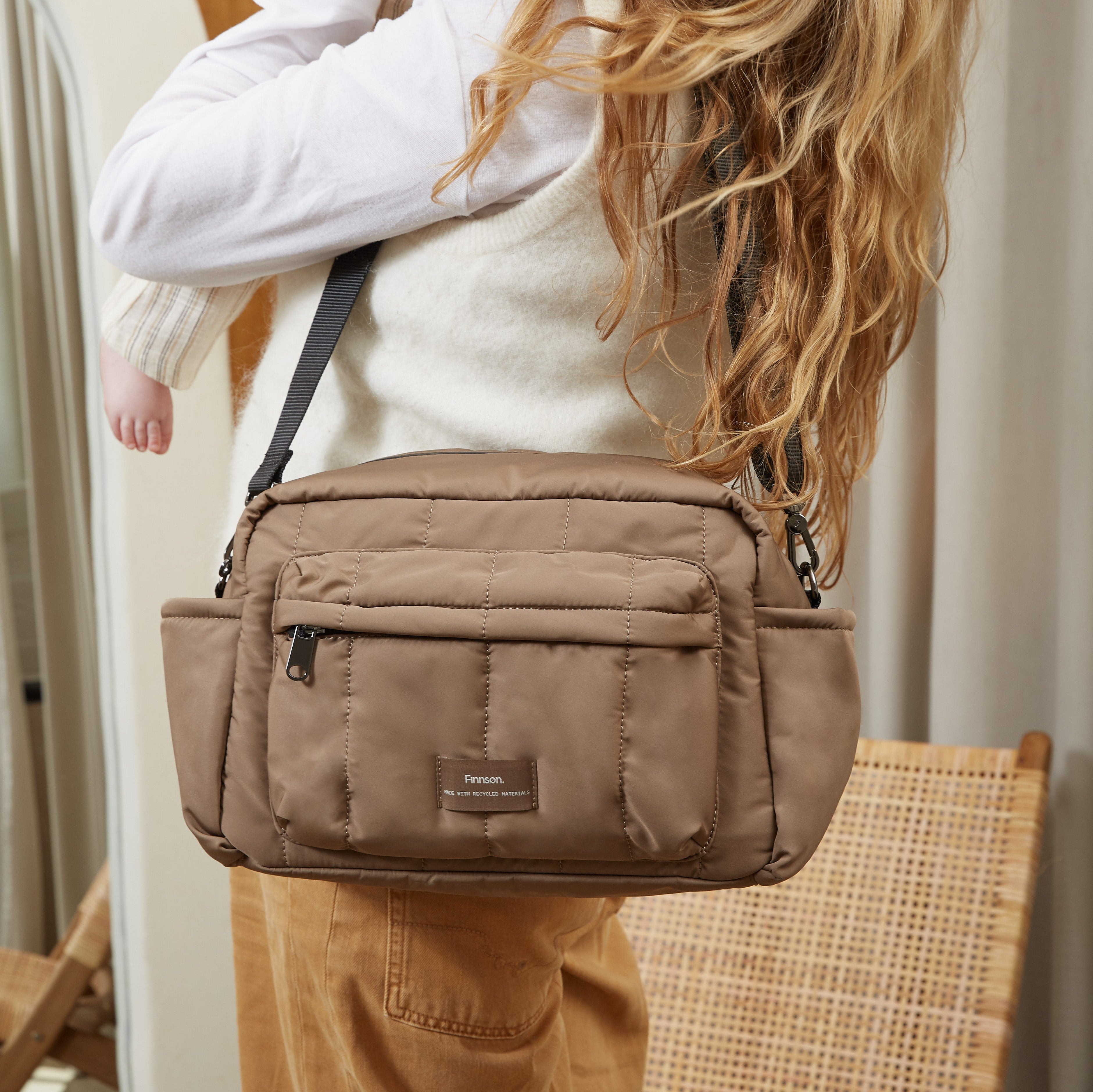 Freya stroller organiser in Mocha worn crossbody, seen from behind