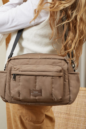 Freya stroller organiser in Mocha worn crossbody, seen from behind