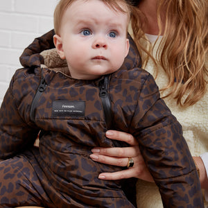 ANDERS Eco Snowsuit Chocolate Leopard close-up of a baby wearing it, showing the front zips and Finnson label