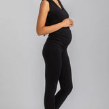Woman wearing a black outfit on a gray background