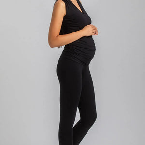 Woman wearing a black outfit on a gray background