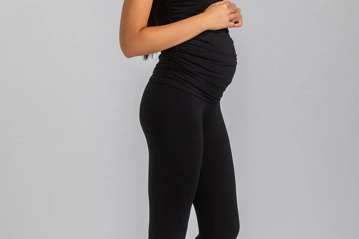 Woman wearing a black outfit on a gray background