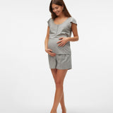 Pregnant woman wearing a gray outfit on a white background