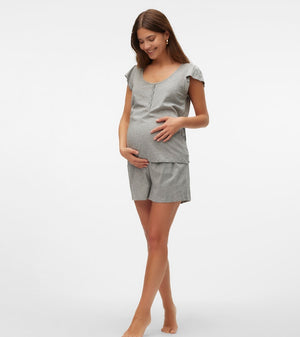 Pregnant woman wearing a gray outfit on a white background