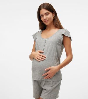 Woman wearing a gray maternity outfit on a white background