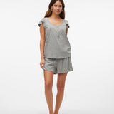 Woman wearing a gray pajama set on a white background