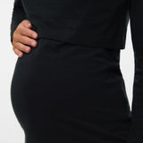 Black dress with a close-up of the waist on a white background