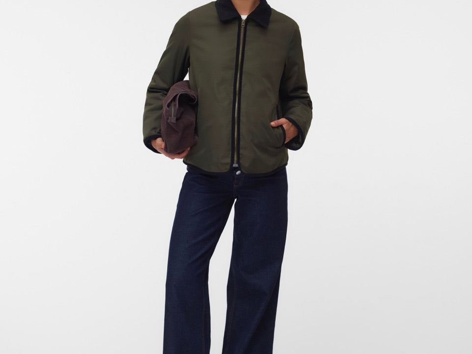 Pregnant woman wearing Khaki green short jacket with black collar and zip front 2