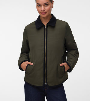 Pregnant woman wearing Khaki green short jacket with black collar and zip front