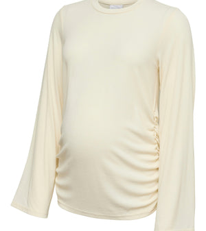 An off-white long-sleeve maternity top with a gathered side seam, shown on a plain white background.