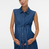 Woman wearing a blue sleeveless dress on a white background