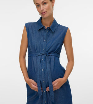 Woman wearing a blue sleeveless dress on a white background