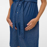 Blue denim dress worn by a person on a white background