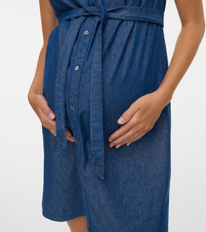 Blue denim dress worn by a person on a white background