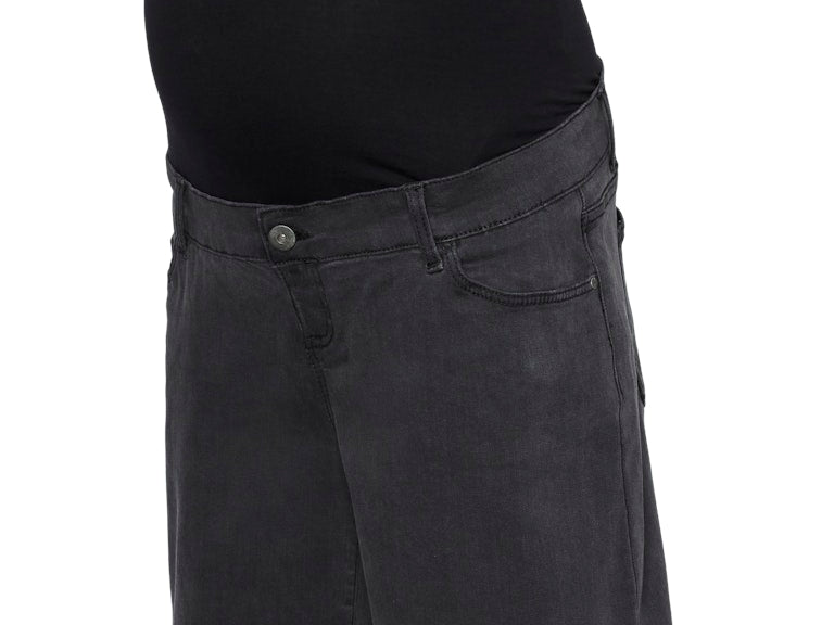 Black denim shorts worn over a black maternity top on a white background