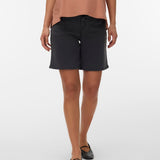 Person wearing black shorts and a brown top on a white background