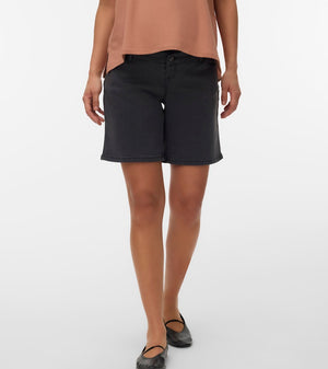 Person wearing black shorts and a brown top on a white background
