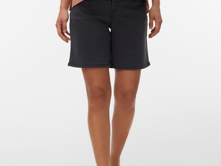 Person wearing black shorts and a brown top on a white background