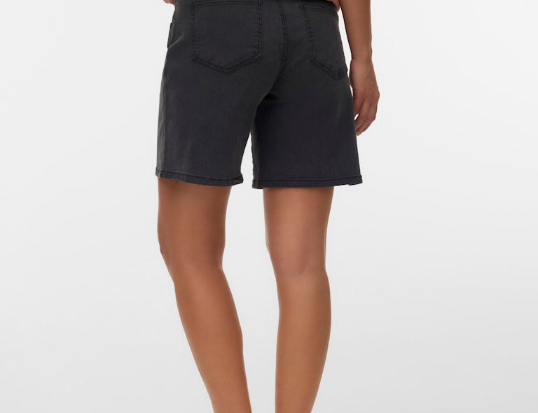 Person wearing black shorts on a white background