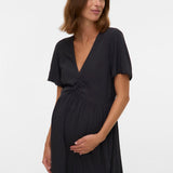 Woman wearing a black dress against a white background