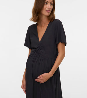 Woman wearing a black dress against a white background
