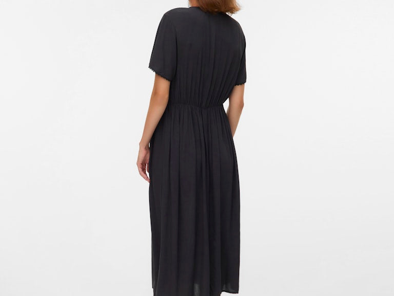 Woman wearing a black dress on a white background