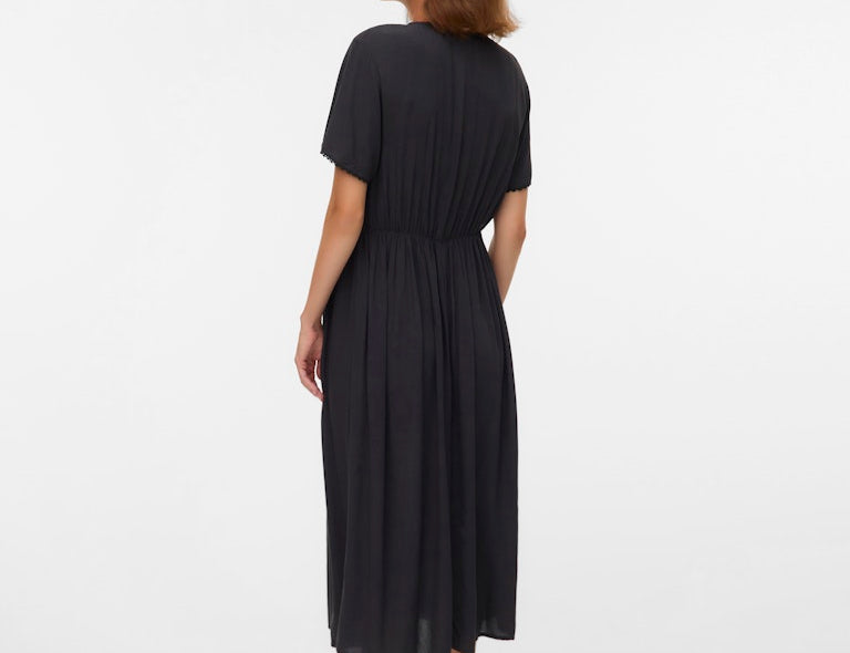 Woman wearing a black dress on a white background