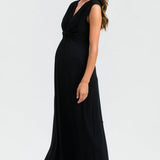 Woman wearing a black sleeveless dress on a white background