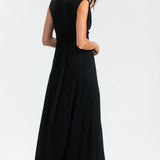 Woman wearing a black sleeveless dress on a white background