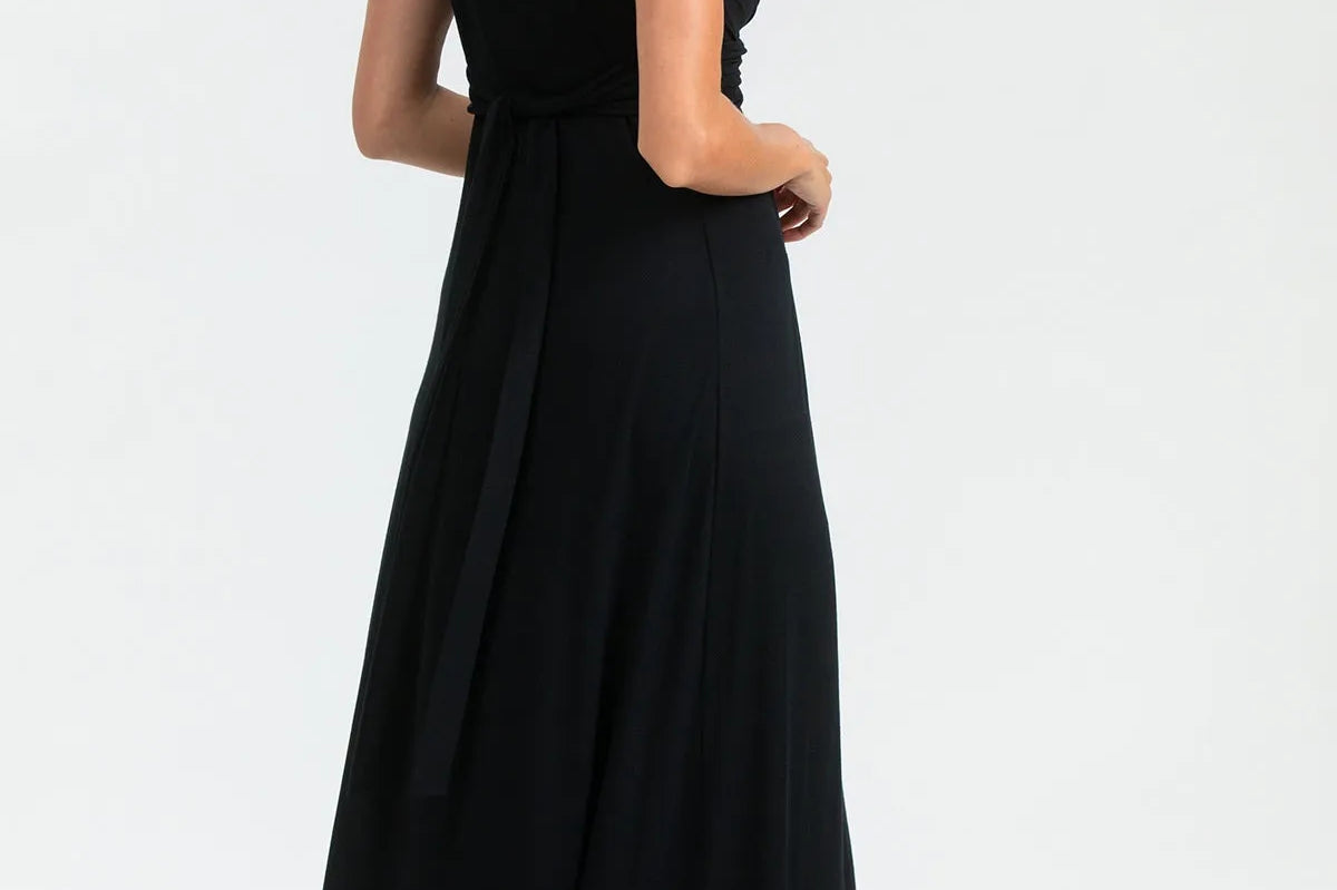 Woman wearing a black sleeveless dress on a white background