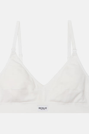 A white wireless bralette with adjustable shoulder straps and a wide underband, featuring the brand name 'RENUE' printed in black on the front center of the band, set against a solid light gray background.