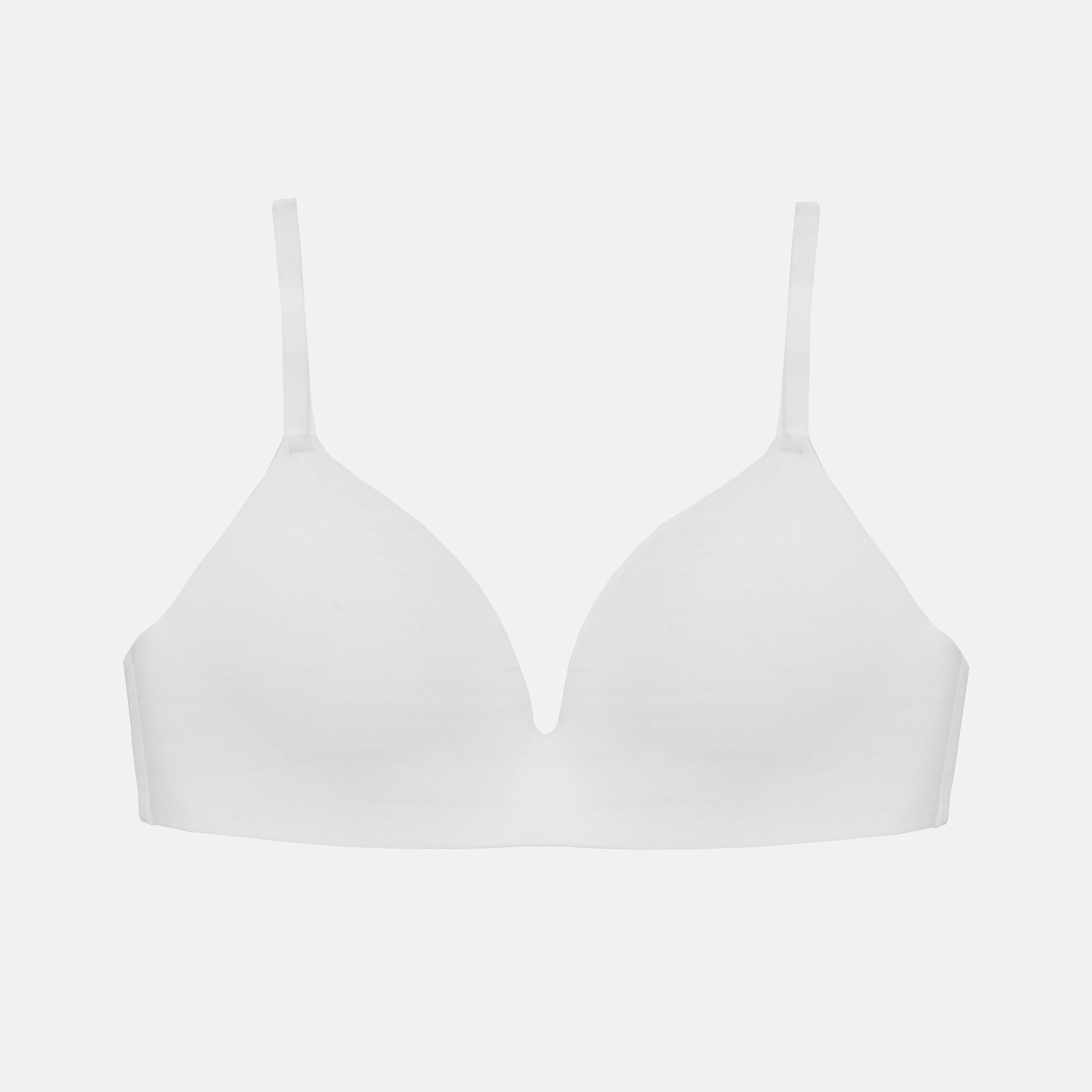 A seamless white underwire bra with thin adjustable shoulder straps, presented on a light gray background.