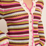Colorful striped crochet cardigan with button details on a neutral background