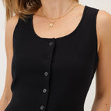 Black sleeveless top with buttons on a white background
