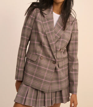 Plaid blazer and skirt set worn by a model on a beige background