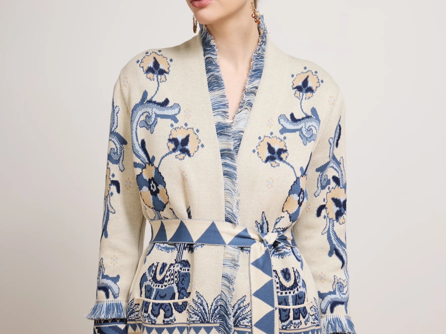Woman wearing a patterned dress with text on a plain background