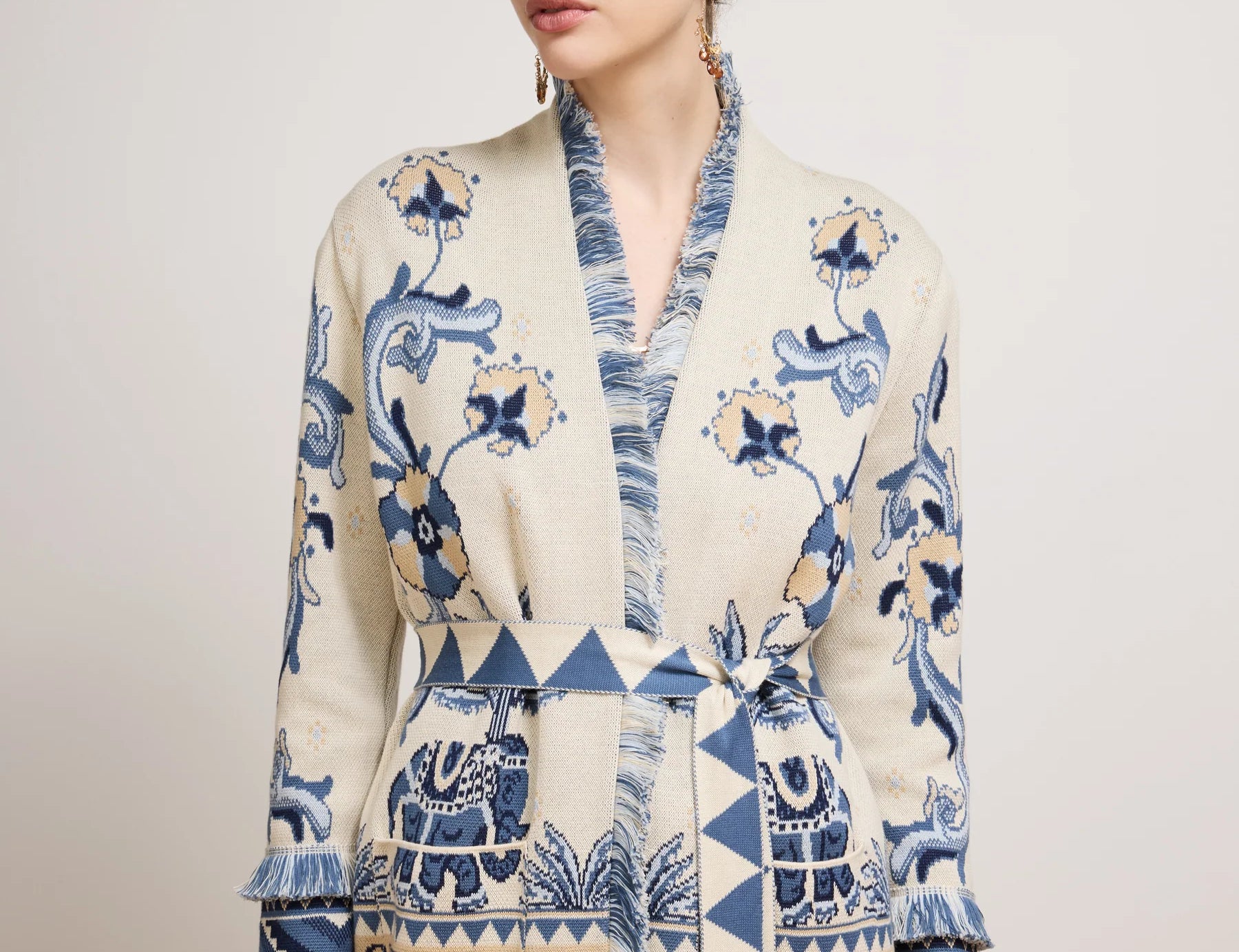 Woman wearing a patterned dress with text on a plain background