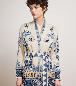 Woman wearing a patterned dress with text on a plain background
