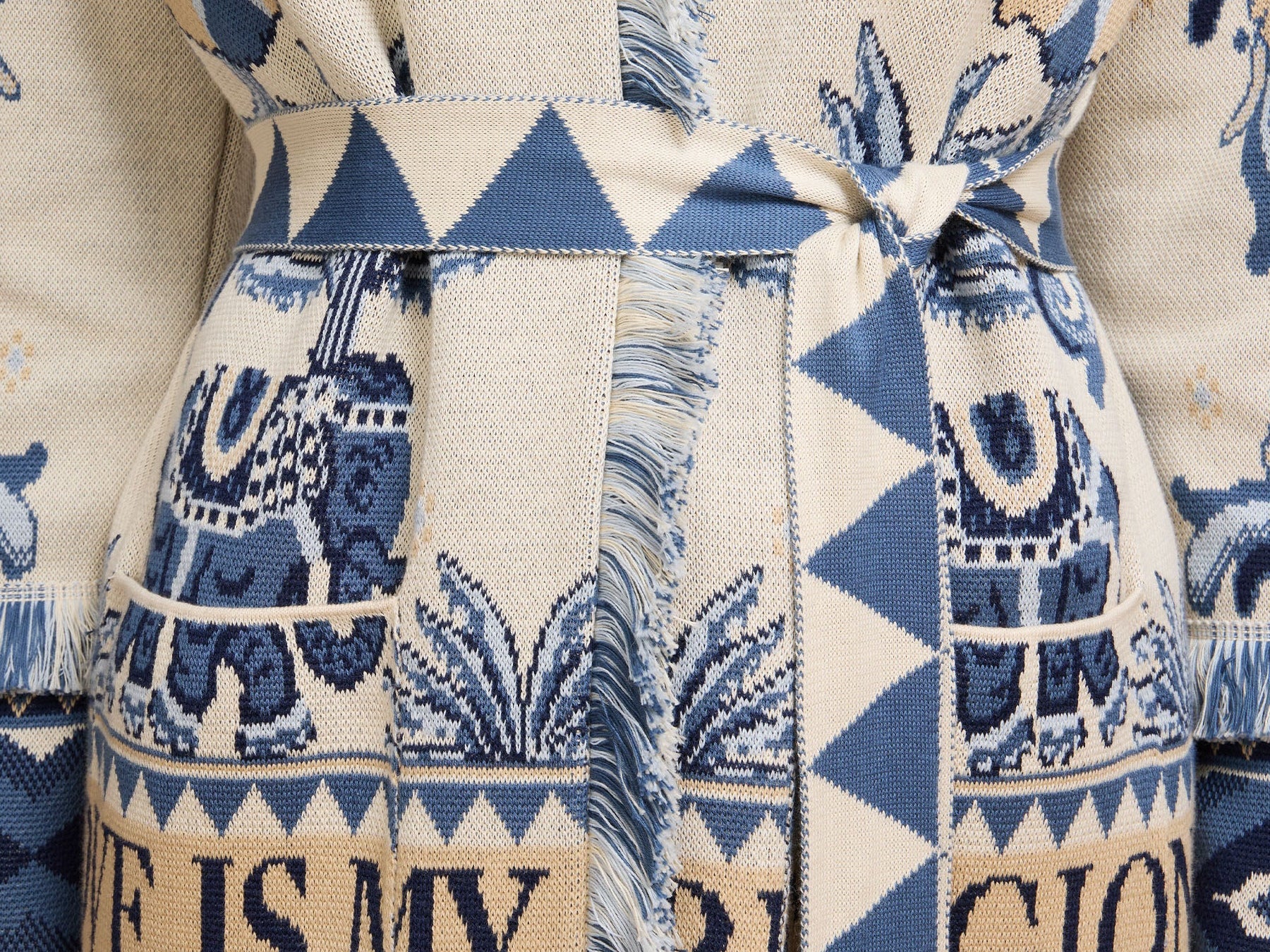 Patterned fabric with blue and beige design featuring text and elephants.