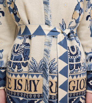 Patterned fabric with blue and beige design featuring text and elephants.