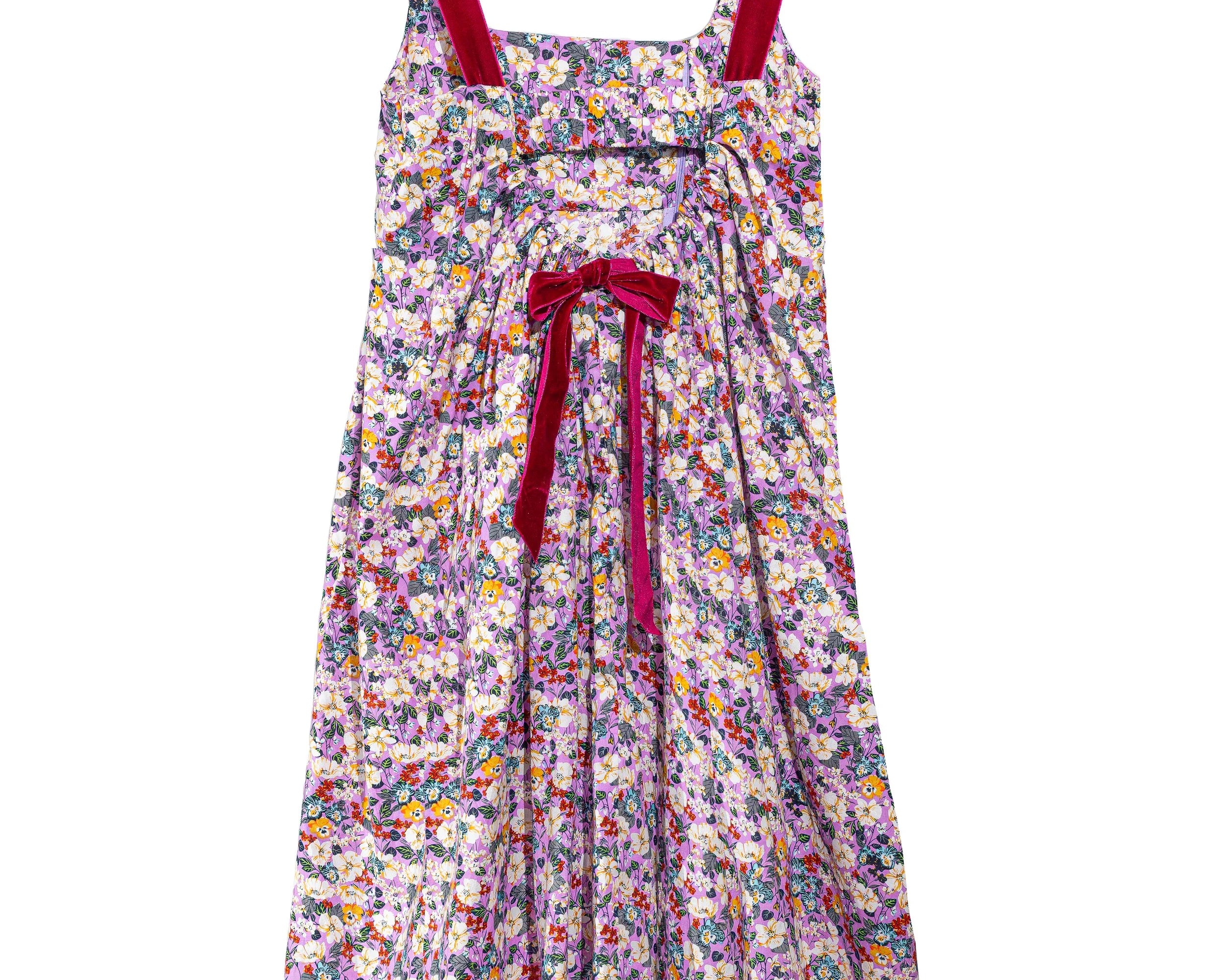 A sleeveless floral midi dress with thin red shoulder straps and a matching red bow at the waist, featuring an all-over multicolor floral print on a light background.