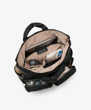 Open black backpack with items inside on a white background