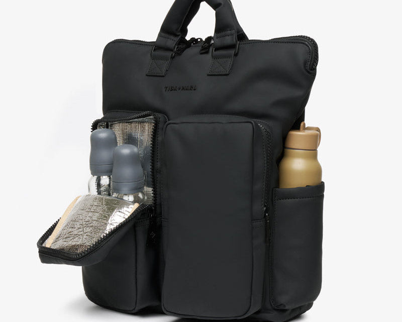 Black backpack with multiple compartments on a white background