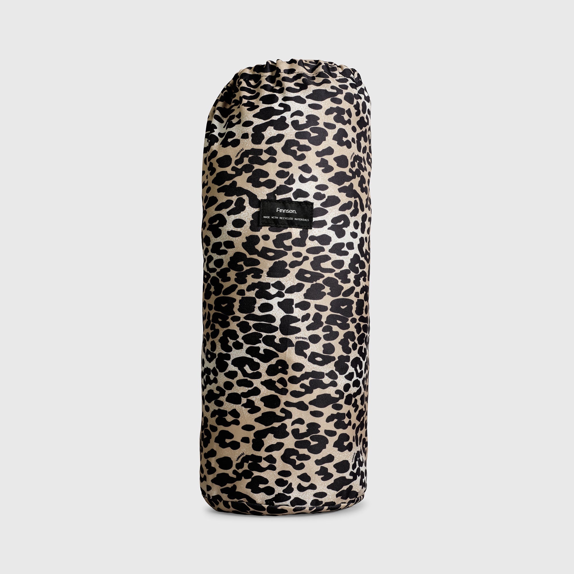 Thoren Eco Playmat in Leopard rolled up inside its drawstring bag, front view with small black label